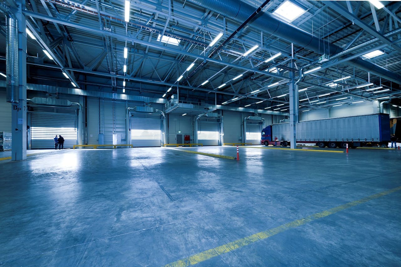 contact-img Large warehouse interior with docked truck, ideal for logistics and warehousing.
